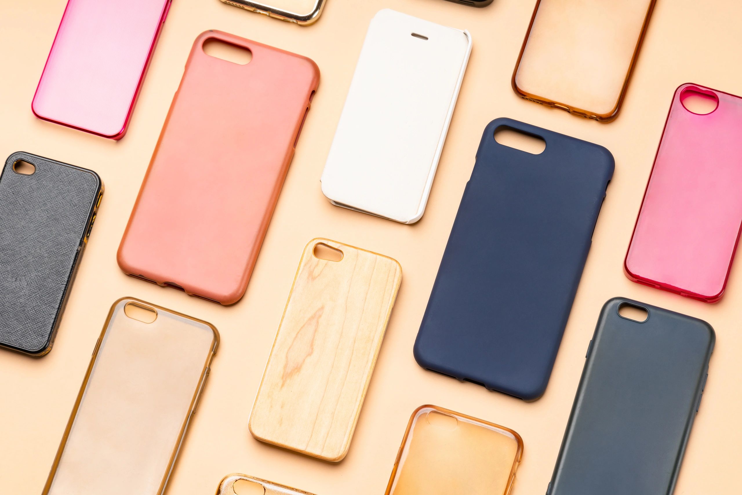 Colorful phone case collection arranged on a neutral background